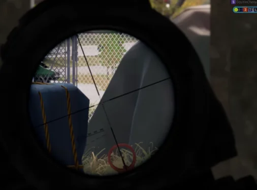 PUBG sniper scope view with red enemy target indicator on a distant player